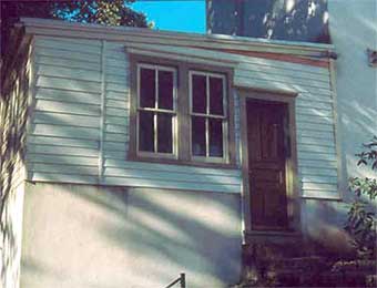 North side exterior, showing siding as replaced. Note section at right of windows, siding duplication of arrangement shown in old photos.