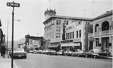 Main Street looking west from Third Avenue. The 1906 National Bank of Coatesville Building with its clock tower is the center of the picture, while the Italianate office of the Chester County Mutual Insurance company stands at the far right.