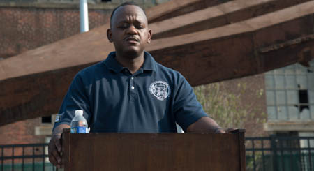 Clarence Smith opens the dedication with a prayer.